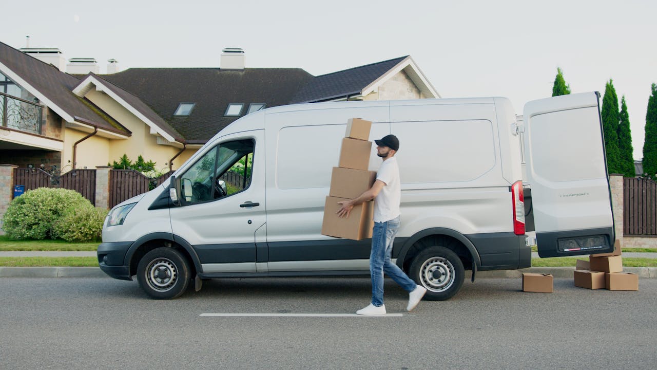 Removals worker carrying boxes from a van — Fair Oak Removals